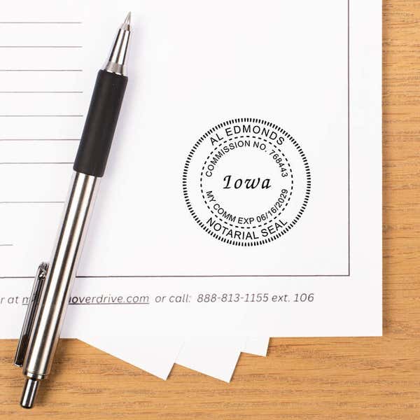 Iowa stamp impression on a white paper with pen.