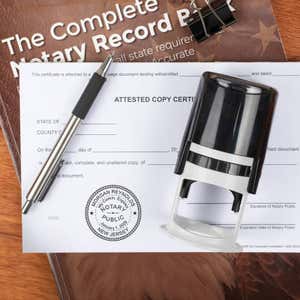 Stamped notary seal beside pen and notary record book