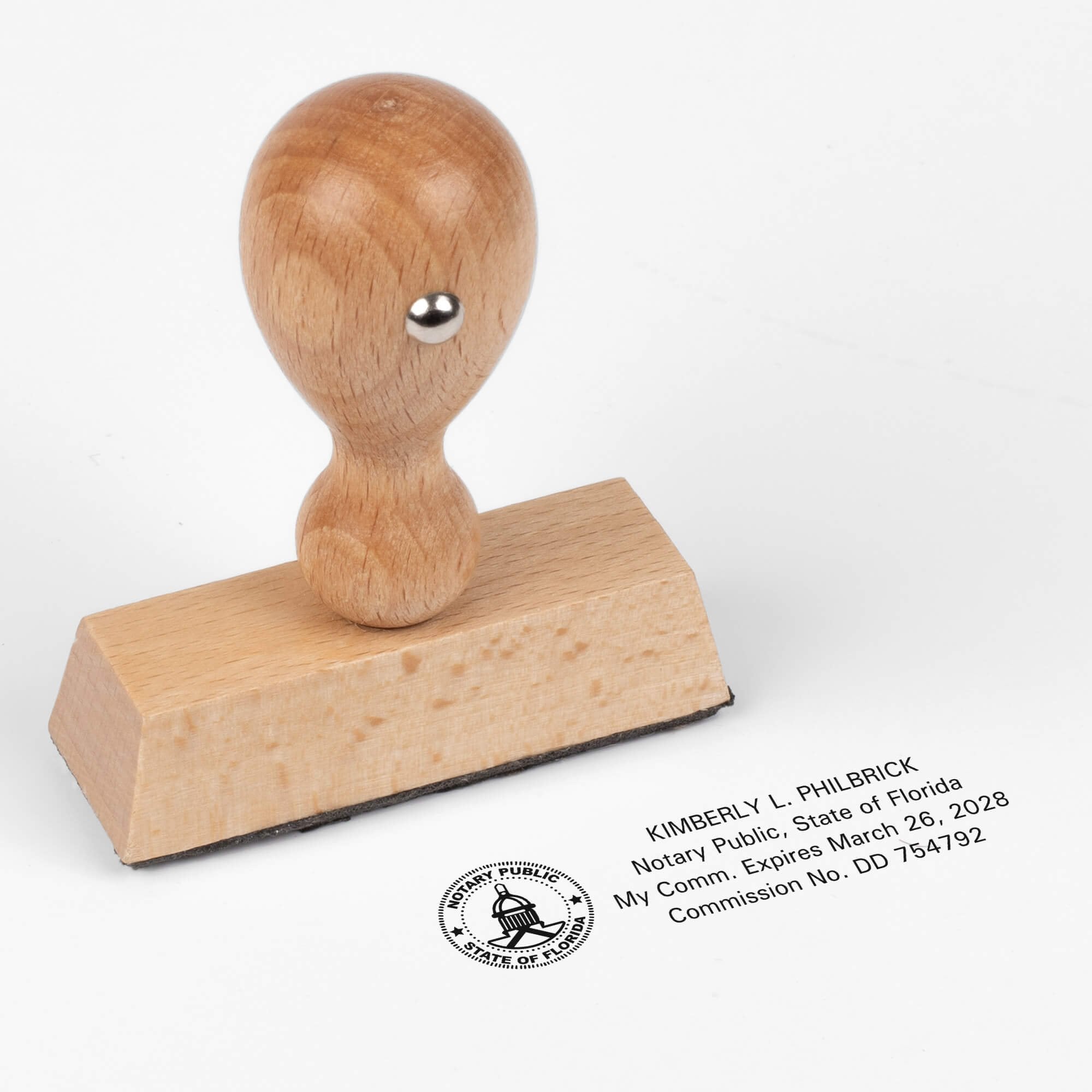 Wood handle notary stamp with Florida notary impression shown on a white background