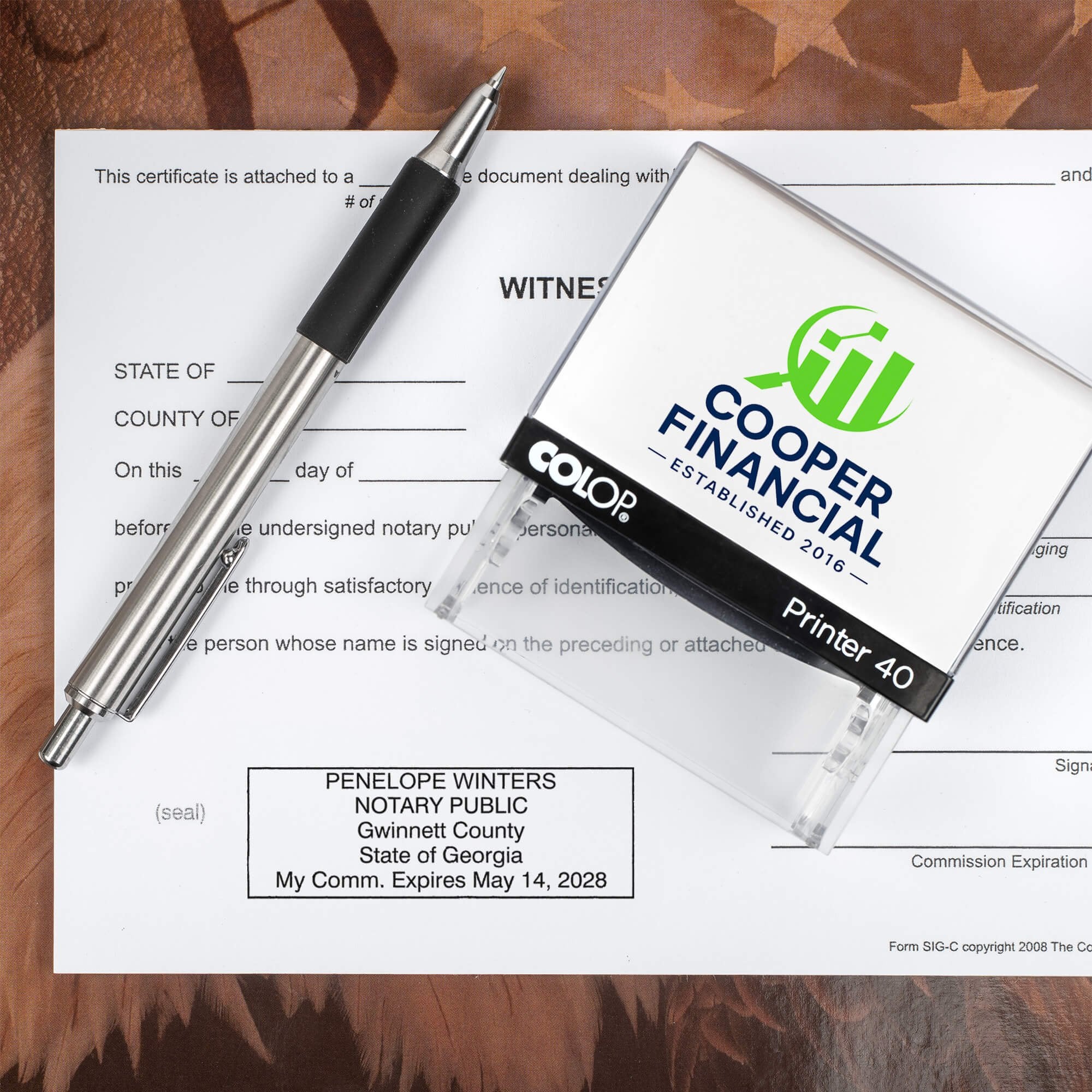 The Custom Georgia Notary Stamp for a financial group being used on a document 