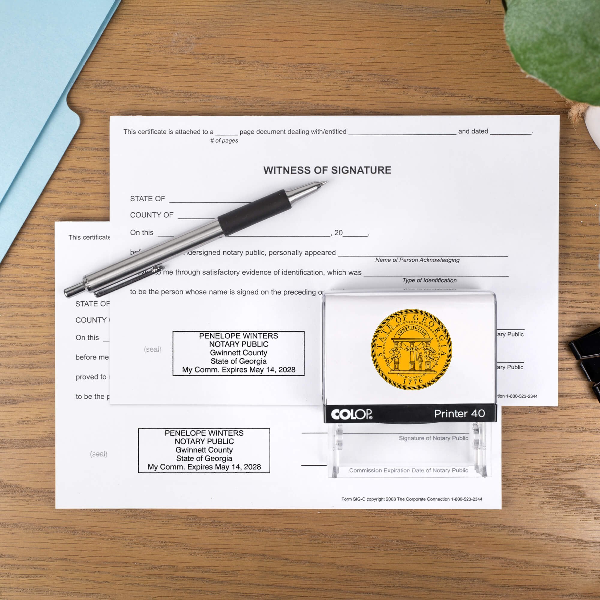 The Custom Georgia Notary Stamp impression on two documents on a desk