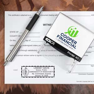 The Custom Massachusetts Notary Stamp for a financial office being used on two documents