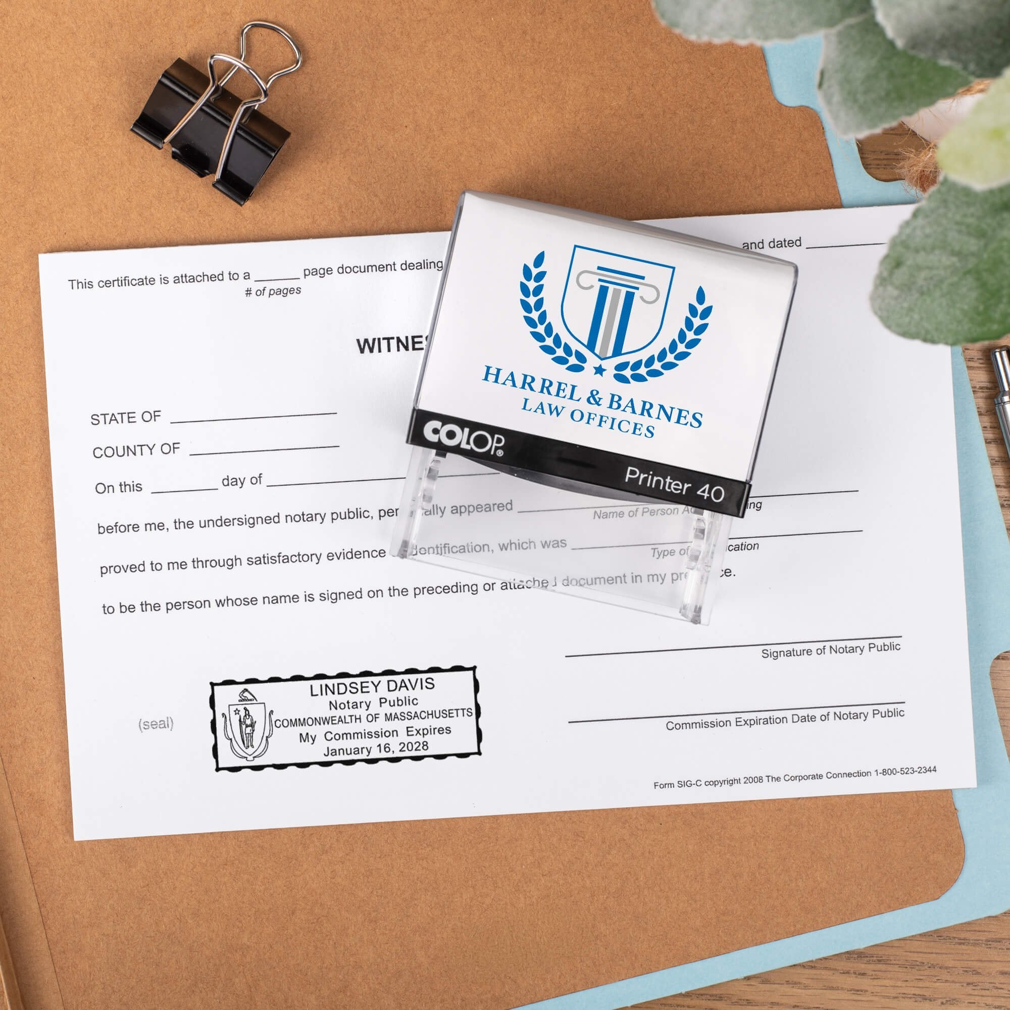 The Custom Massachusetts Notary Stamp for a law office being used on a document