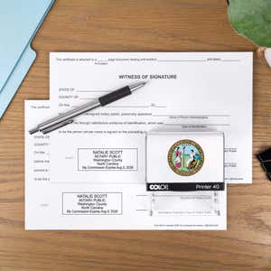 The Custom North Carolina Notary Stamp with a personal logo on two documents