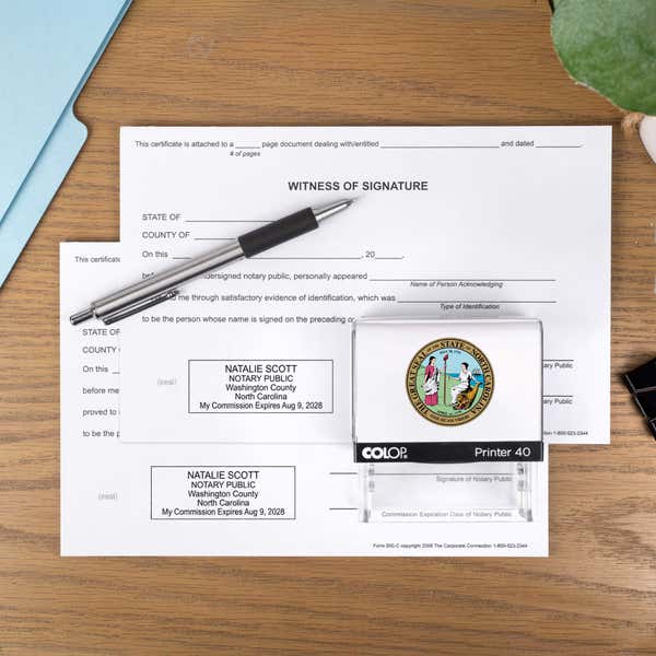 The Custom North Carolina Notary Stamp with a personal logo on two documents