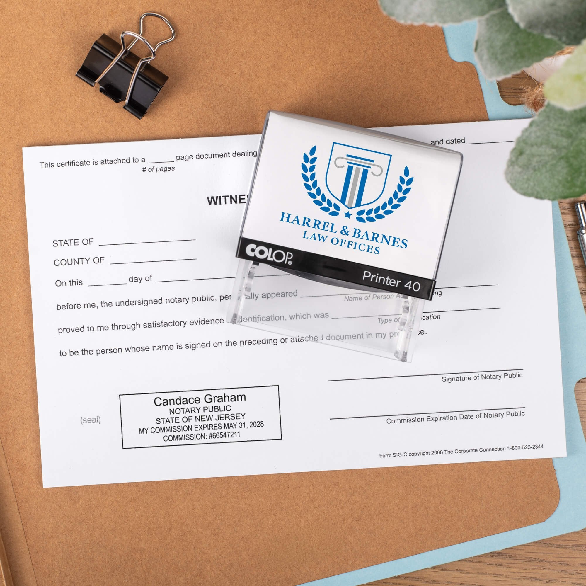 The Custom New Jersey Notary Stamp impression on a document next to the stamp body