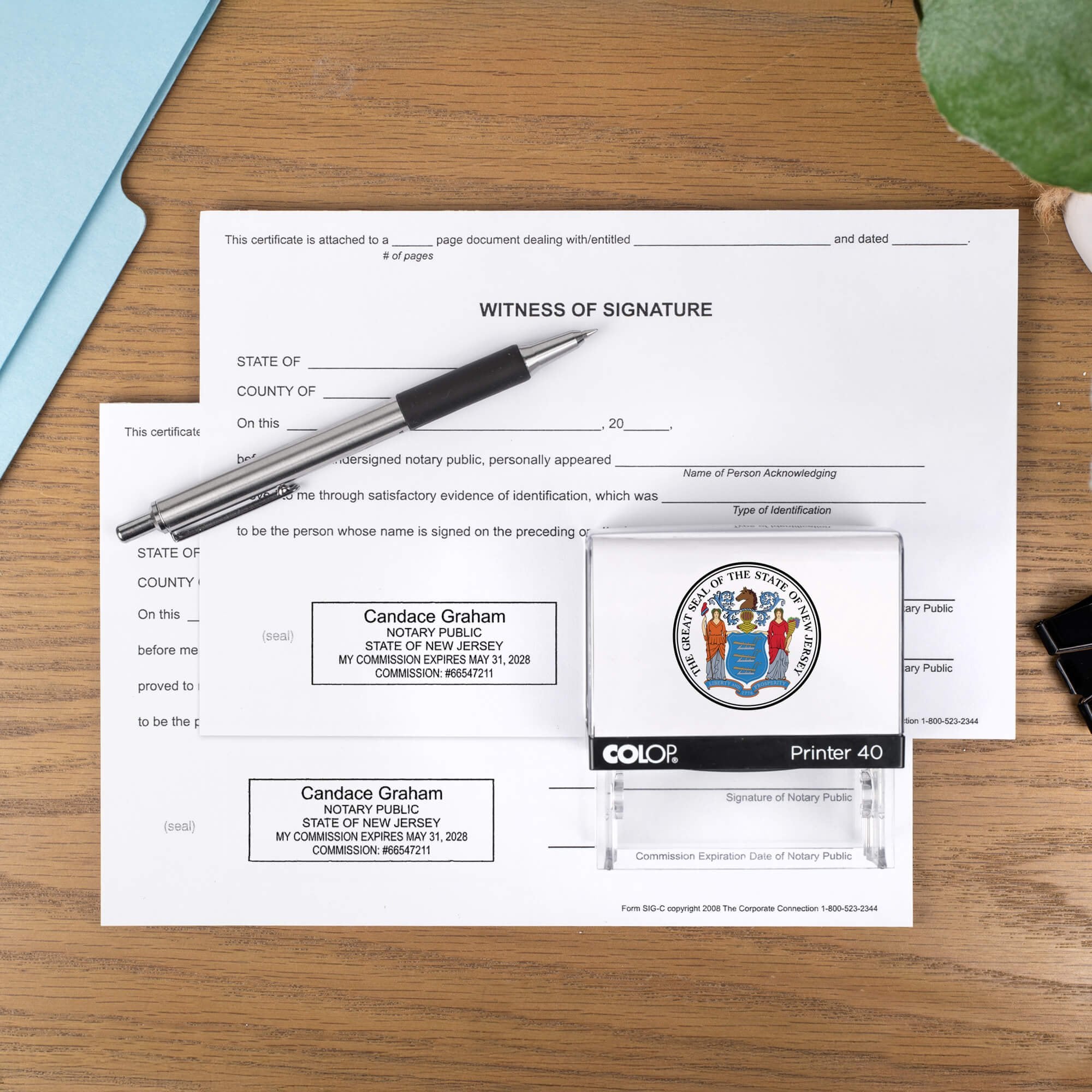 The Custom New Jersey Notary Stamp impression on two documents next to a pen