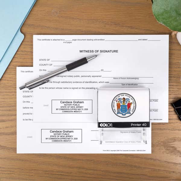The Custom New Jersey Notary Stamp impression on two documents next to a pen