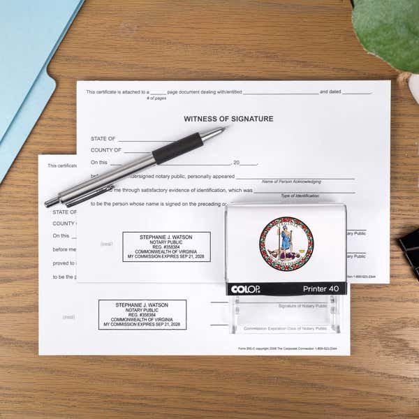 The Virginia Notary Stamp with Custom Logo laysing on paper next to a stamp impression