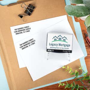 Address stamp for a company called Legacy Mortgage with two stamp impressions on paper